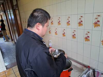 先天視障者呂坤諭在樂明中心生活自理老師訓練下 可以自己用電鍋烹調食物
