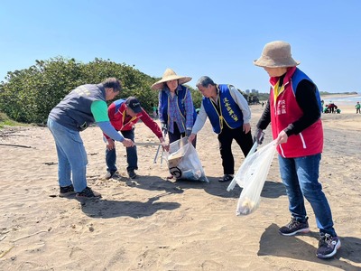 淡水興仁里關懷據點長輩和興仁國小學生老幼同行一起淨灘,左1為興仁里長盧仁澤。